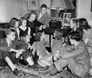 Image of family sitting around radio listening intently