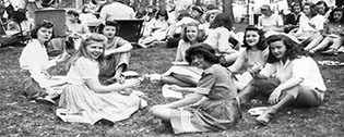 Image of students sitting in a circle on the ground