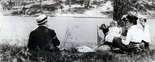 A family sitting on the shores of Chevy Chase Lake
