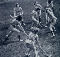 Students playing field hockey