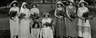 Group image of students posing with bouquets of flowers