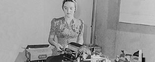Woman working a mimeograph machine
